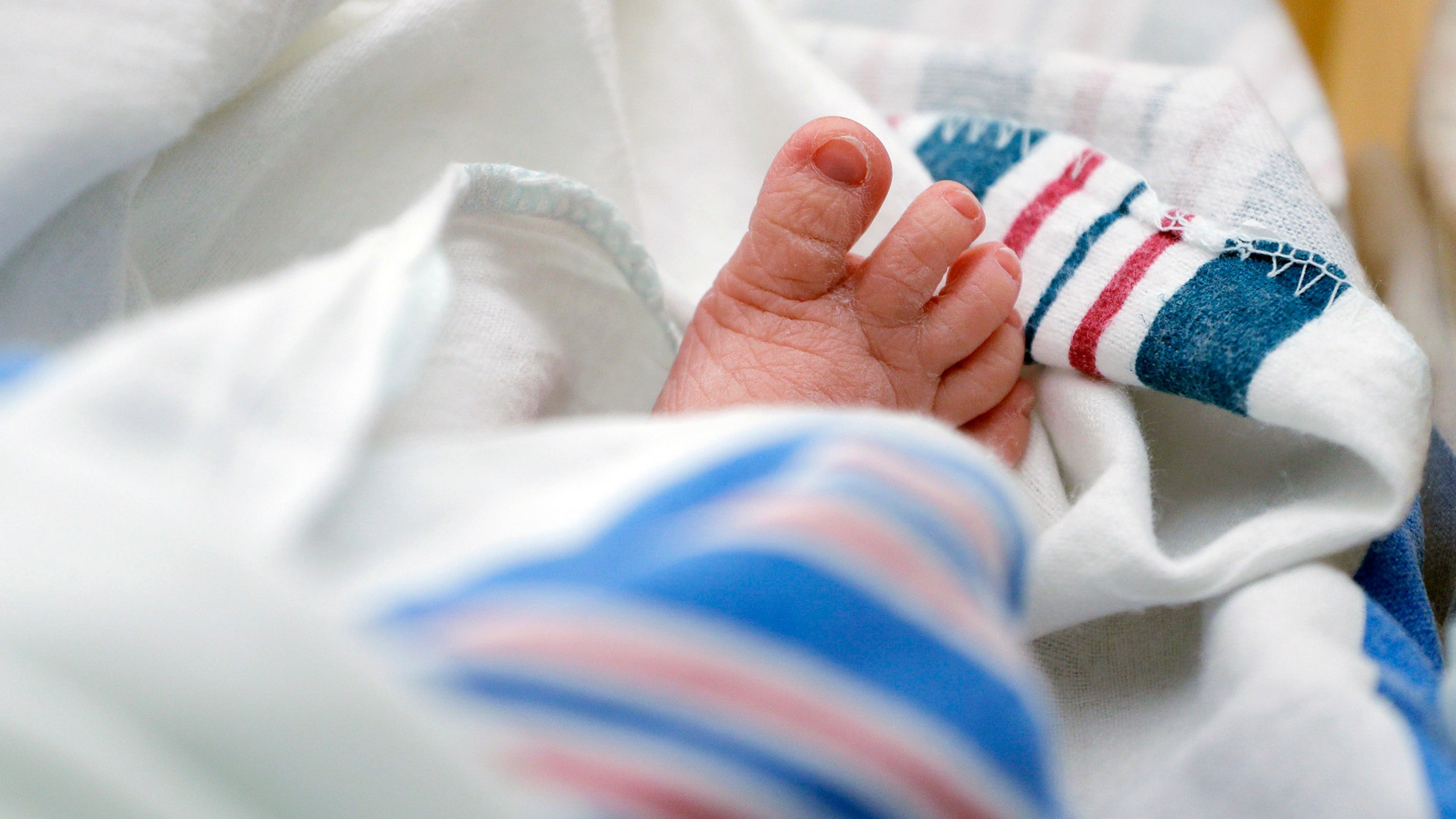 FILE - The toes of a baby peek out of a blanket at a hospital in McAllen, Texas. On Wednesday, Nov. 1, 2023, the Centers for Disease Control and Prevention reported the increase of U.S. infant mortality rate to 3% in 2022 — a rare increase in a death statistic that has been generally been falling for decades. (AP Photo/Eric Gay, File)