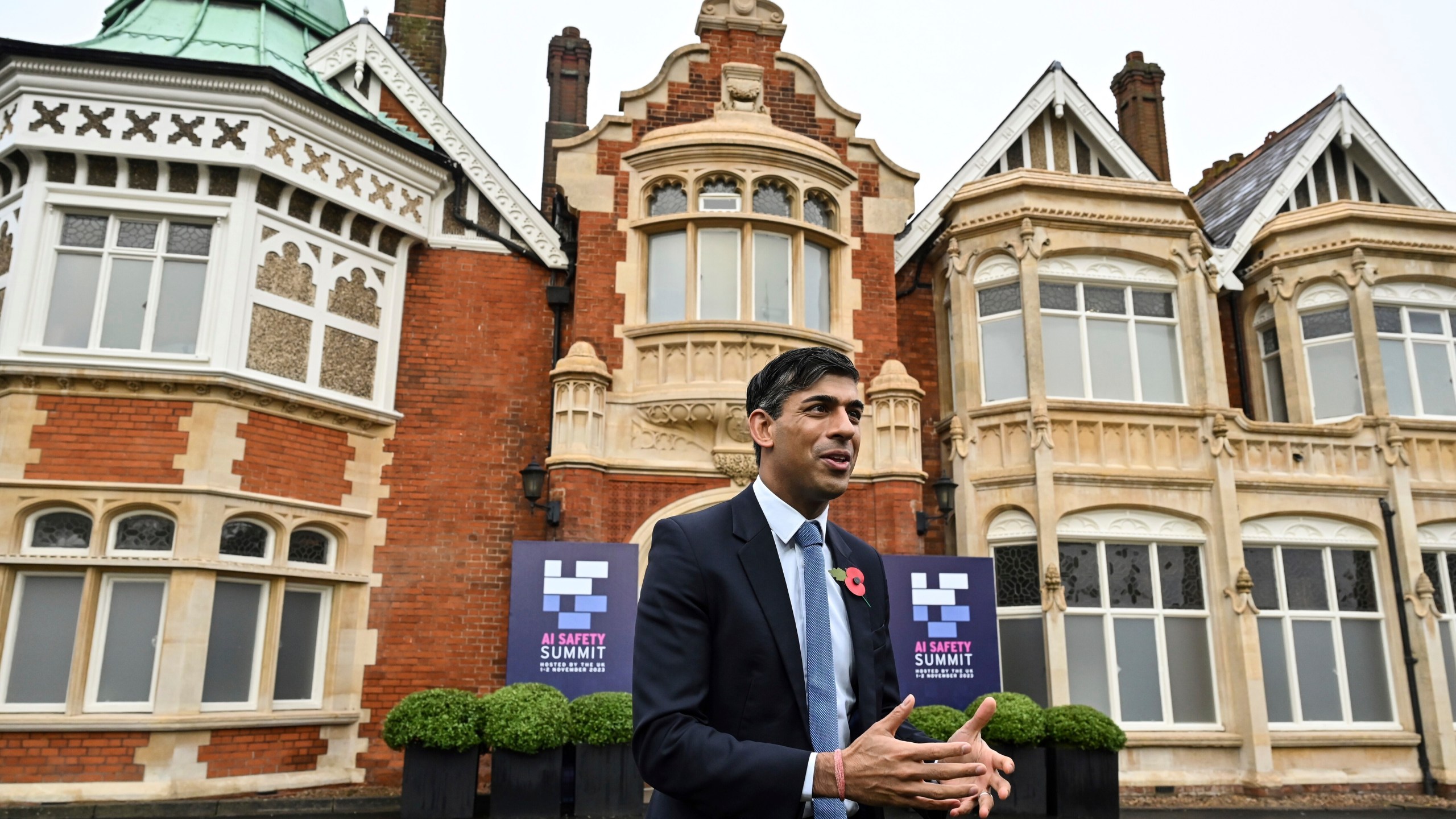 Britain's Prime Minister Rishi Sunak speaks to journalists upon his arrival for the second day of the UK Artificial Intelligence (AI) Safety Summit, at Bletchley Park, in Bletchley, England, Thursday, Nov. 2, 2023. U.S. Vice President Kamala Harris and British Prime Minister Rishi Sunak are set to join delegates Thursday at a U.K. summit focused on containing risks from rapid advances in cutting edge artificial intelligence. (Justin Tallis/Pool Photo via AP)