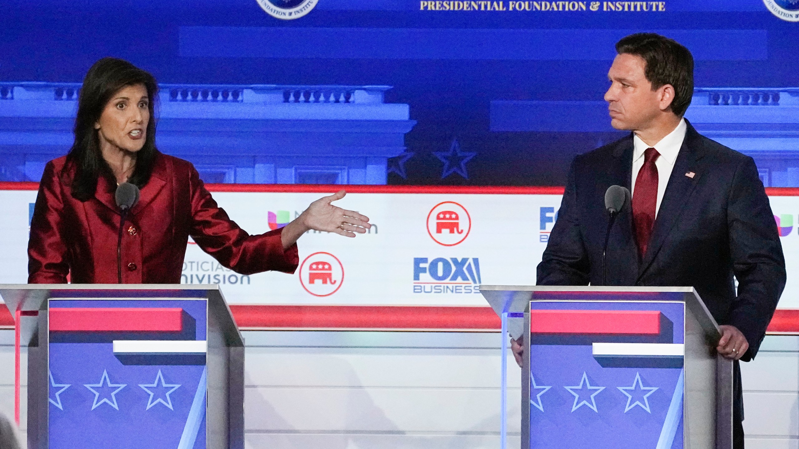 FILE - Republican presidential candidate and former U.N. Ambassador Nikki Haley, left, with Florida Gov. Ron DeSantis, speaks during a Republican presidential primary debate hosted by FOX Business Network and Univision, Sept. 27, 2023, at the Ronald Reagan Presidential Library in Simi Valley, Calif. Haley has been rising with donors and voters thanks in part to strong debate performances and the campaign's increased focus on foreign policy. That's come partly at the expense of Florida Gov. Ron DeSantis. But donors and voters seeking an alternative to former President Donald Trump haven't fully coalesced around Haley. (AP Photo/Mark J. Terrill, File)