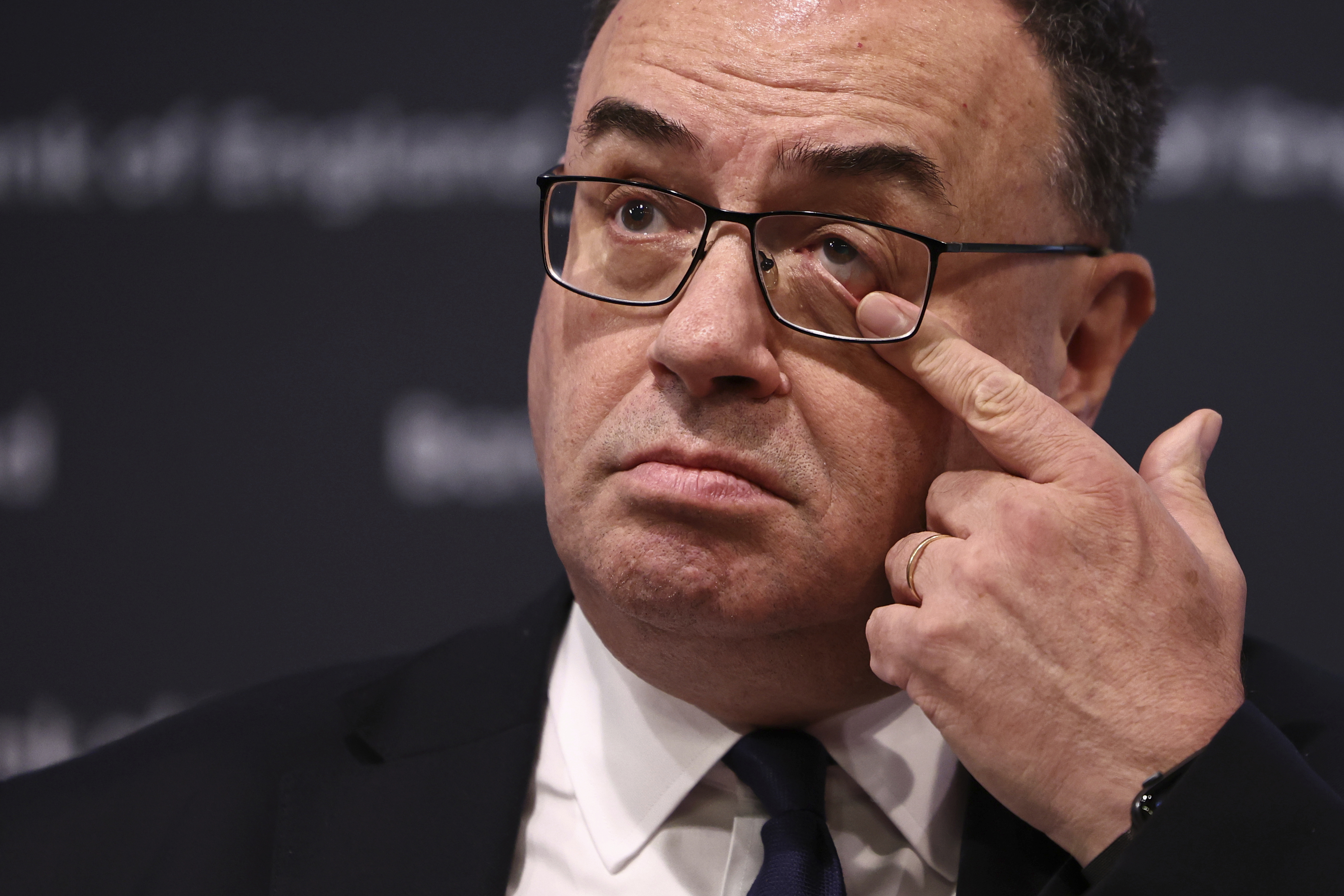 Governor of the Bank of England Andrew Bailey touches his eye as he arrives to address the media during a press conference concerning interest rates, at the Bank of England, in London, Thursday, Nov. 2, 2023. The Bank of England kept its main interest rate unchanged on Thursday at the 15-year high of 5.25% and indicated that borrowing costs will likely remain at these sort of elevated levels for a while, especially if oil and gas prices increase sharply in light of the conflict between Israel and Hamas. (Henry Nicholls/Pool Photo via AP)