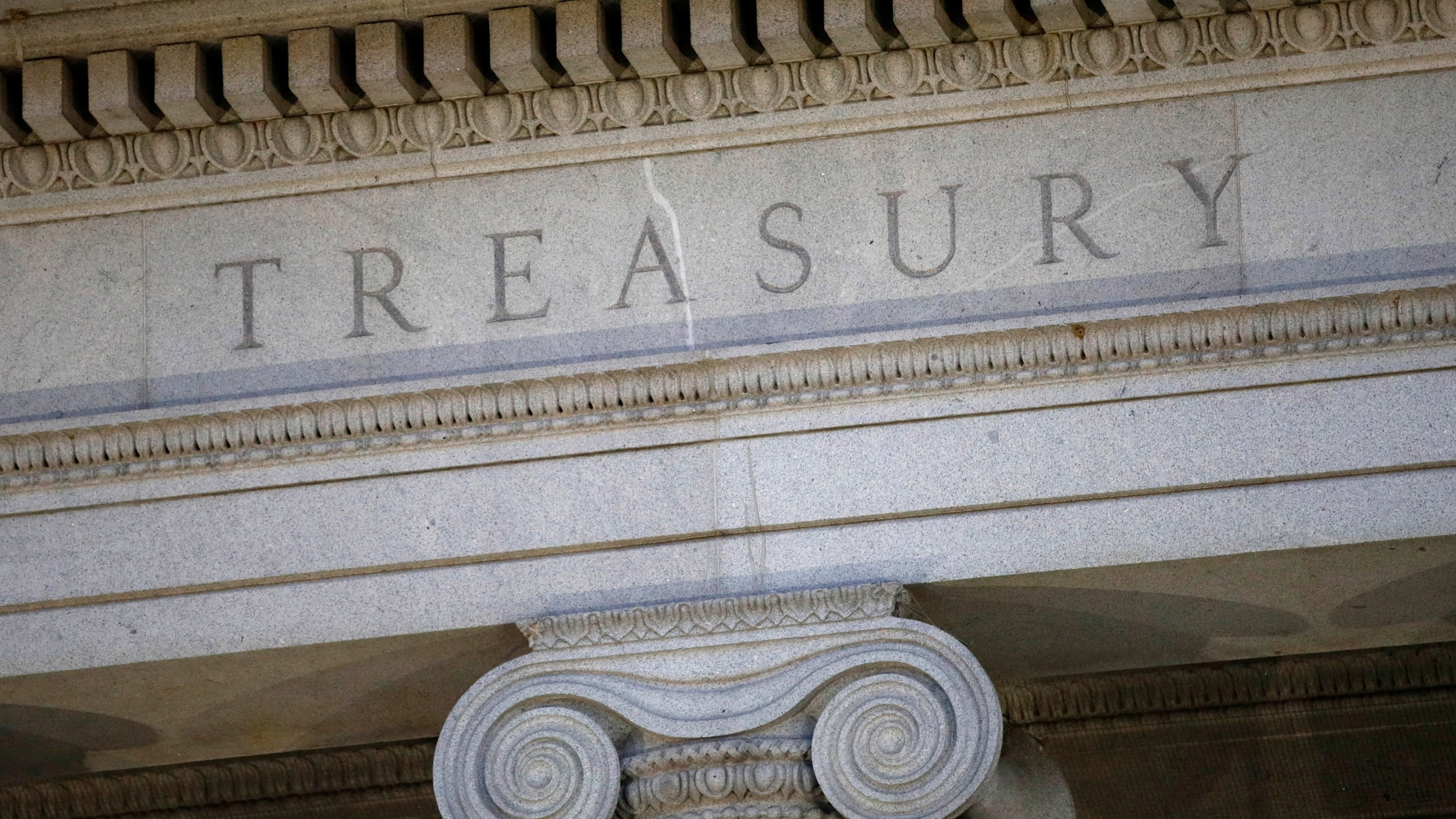 FILE- The U.S. Treasury Department building is shown at dusk in Washington on June 6, 2019. The United States on Thursday imposed a new round of sanctions on roughly 130 firms and people from Turkey to China to the United Arab Emirates in an effort to choke off Moscow’s access to tools and equipment that support its invasion of Ukraine. (AP Photo/Patrick Semansky, File)